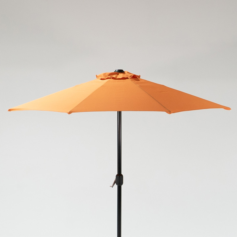 Green patio umbrella with a central pole, set against a light grey background.