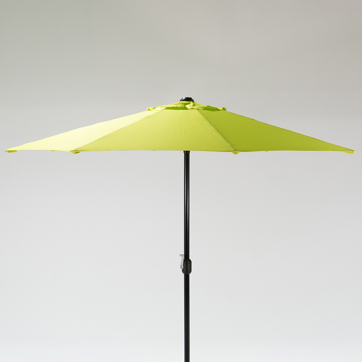 Lime outdoor umbrella with a spacious canopy and a sturdy pole, set against a light grey background.
